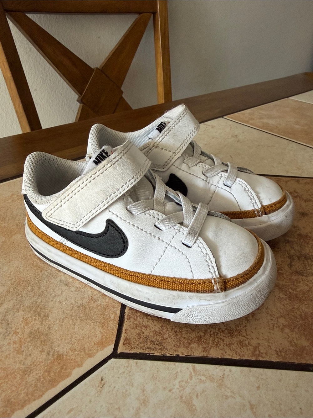 Nike Kids White Sneaker with Black Swoosh and Tan Trim